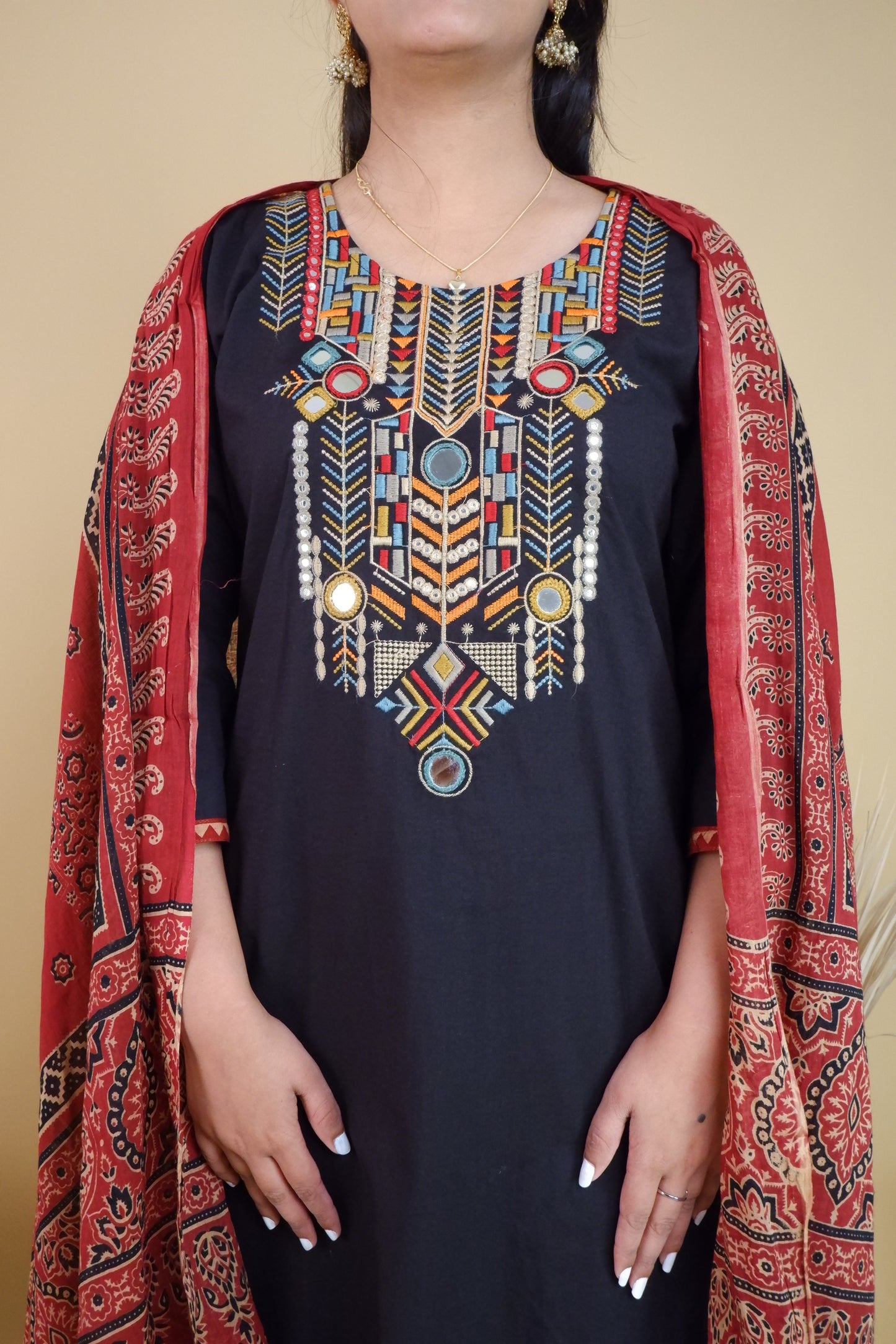Black cotton festive suit with colorful geometric embroidery and red printed dupatta from Dharini's Store