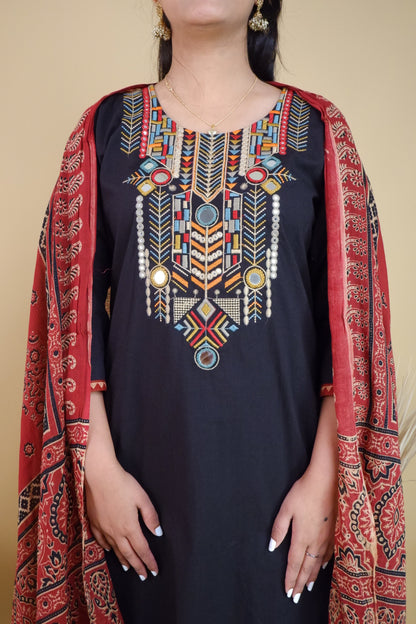 Black cotton festive suit with colorful geometric embroidery and red printed dupatta from Dharini's Store