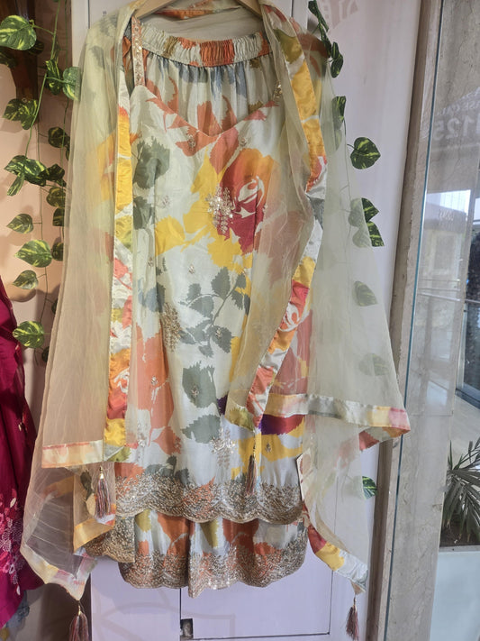Floral printed chanderi silk embroidered suit with sheer dupatta displayed on a hanger