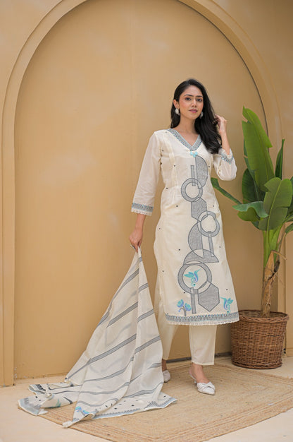 Woman wearing cream embroidered suit set with geometric and floral embroidery standing indoors
