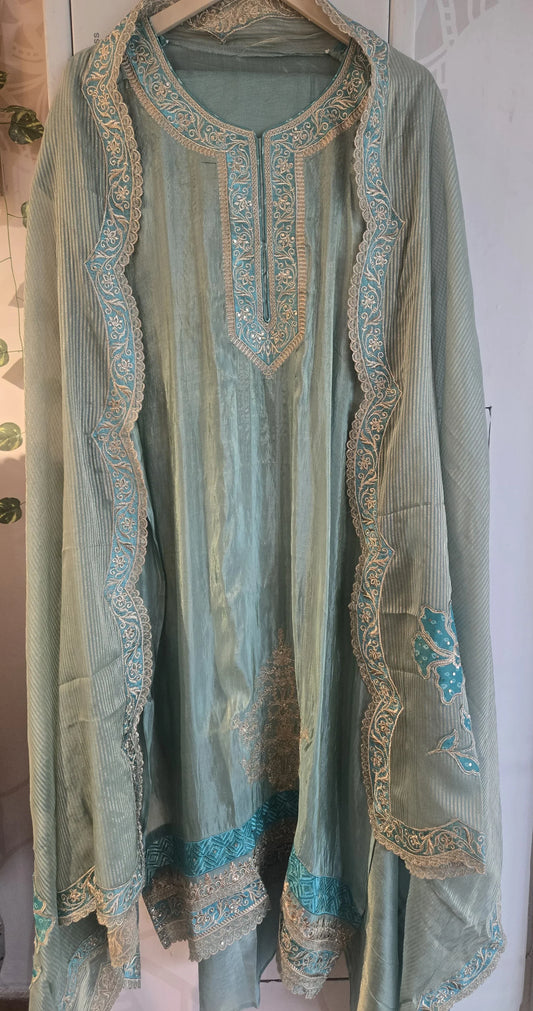 Sea green pure silk suit with intricate embroidery and detailed border from Dharini's Store