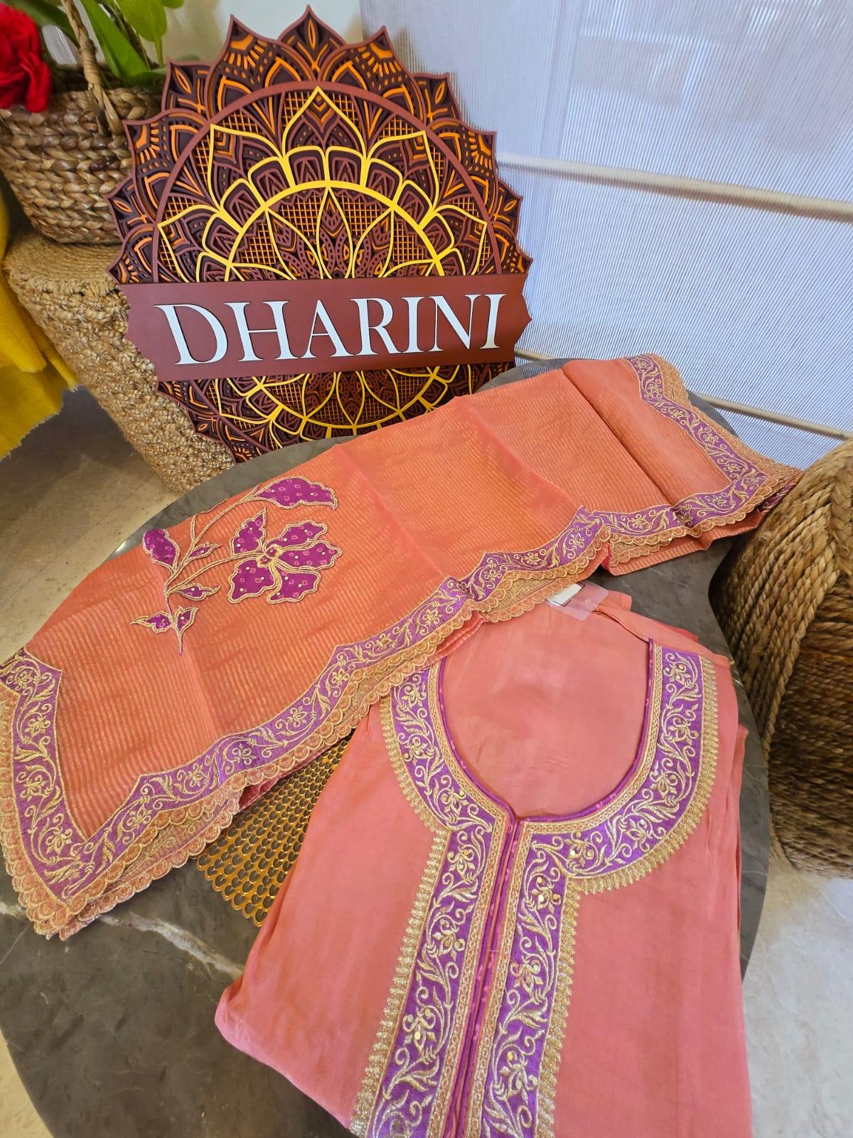 Peach shimmer unstitched suit with purple and gold embroidery detailed neckline and floral design