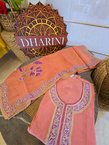 Peach shimmer unstitched suit with purple and gold embroidery detailed neckline and floral design
