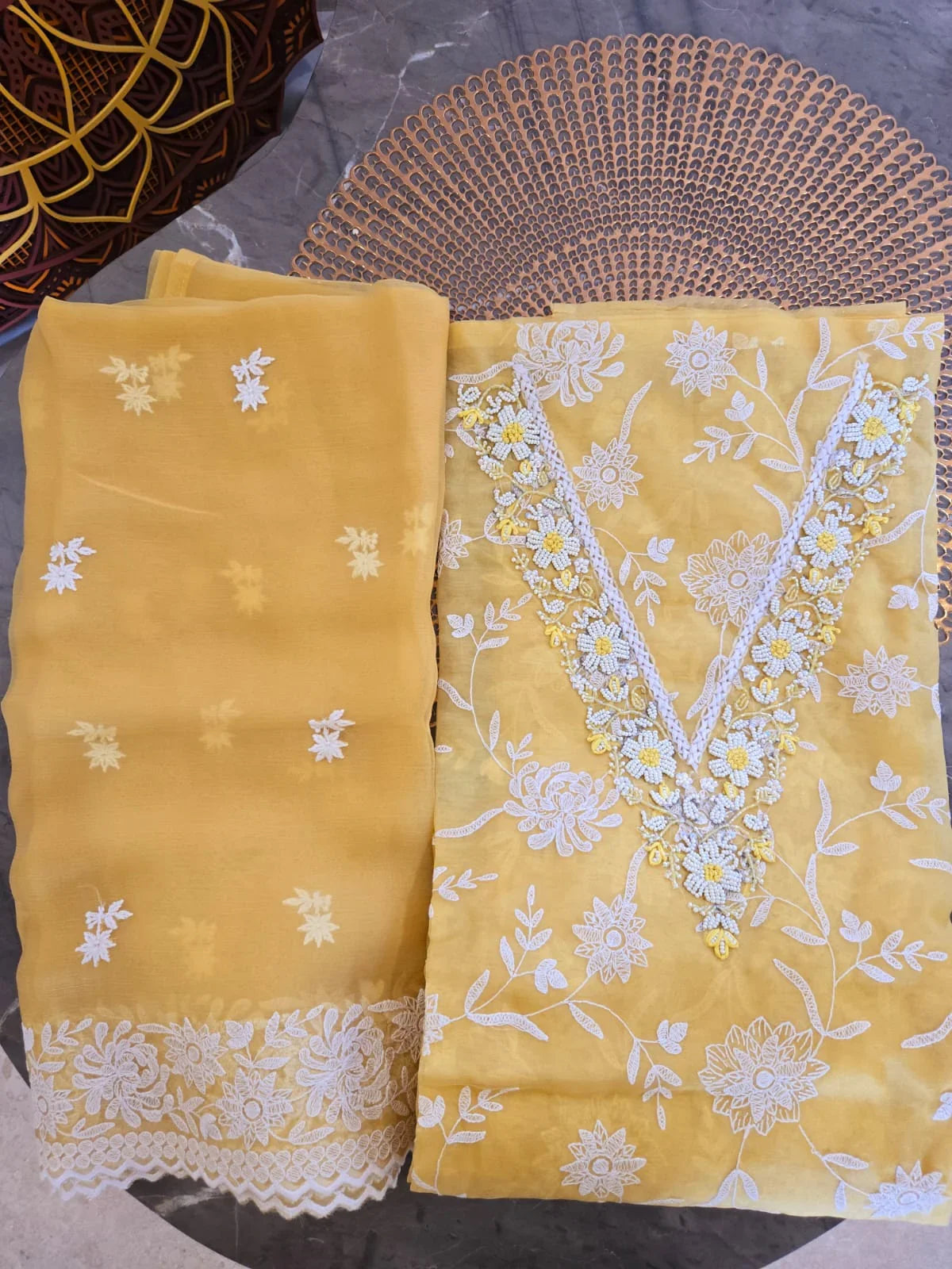 Yellow embroidered thread work suit with white floral designs and lace details from Dharini's Store