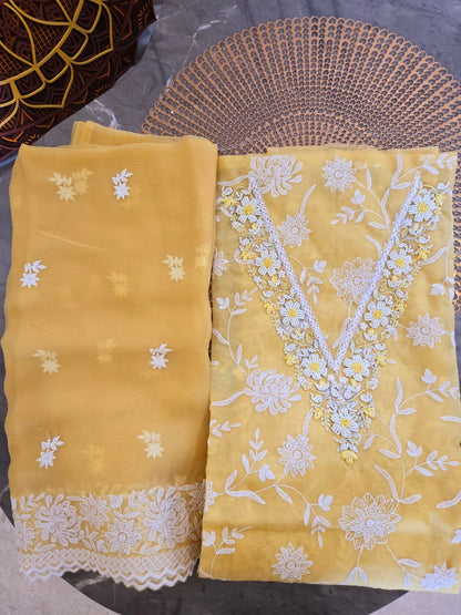 Yellow embroidered thread work suit with white floral designs and lace details from Dharini's Store