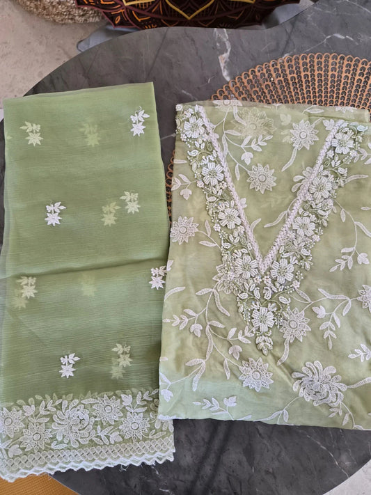 Light green embroidered thread work suit with floral white thread embroidery and delicate lace border