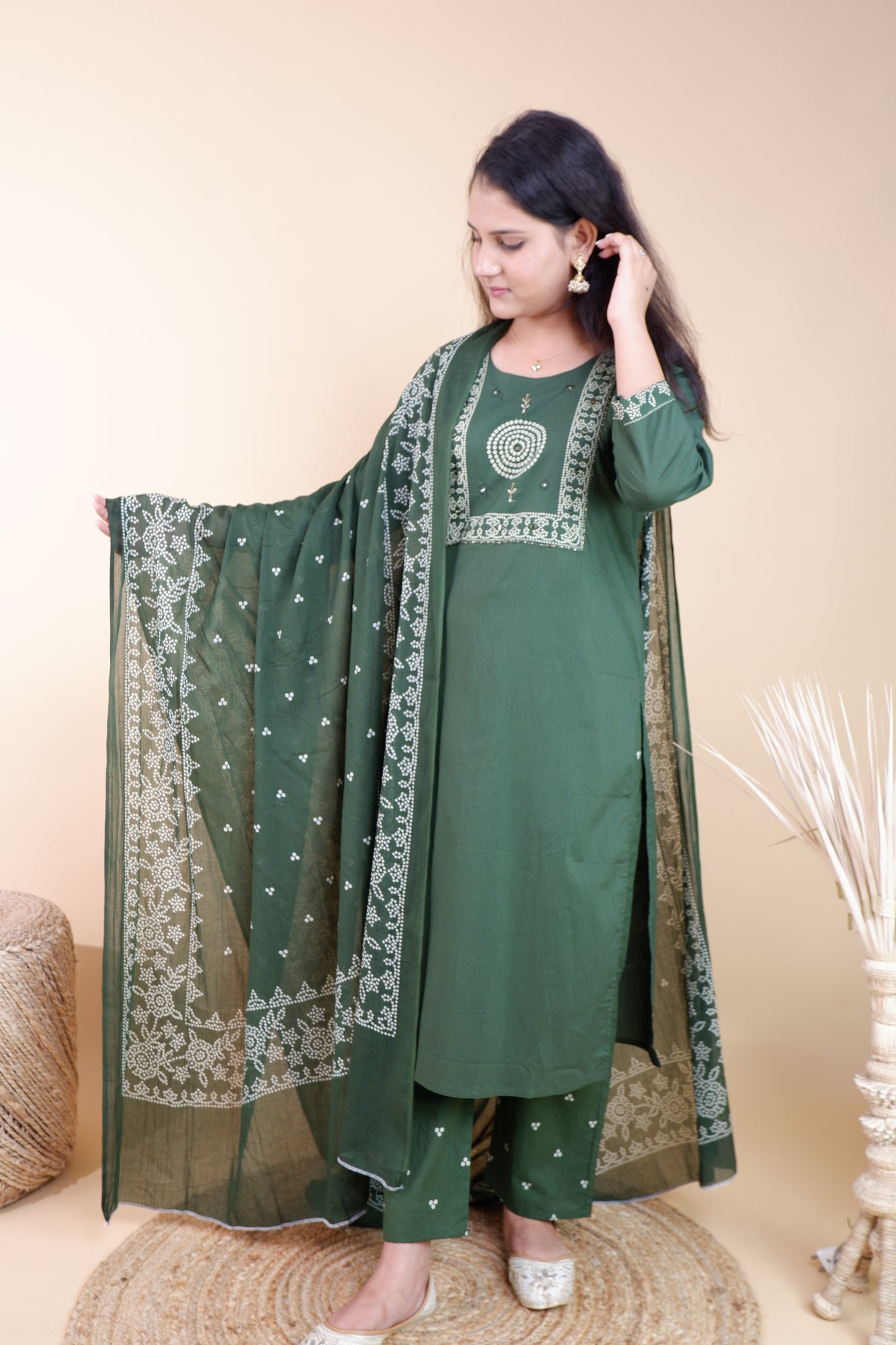 Woman wearing an olive green cotton suit for women with white embroidery and matching dupatta
