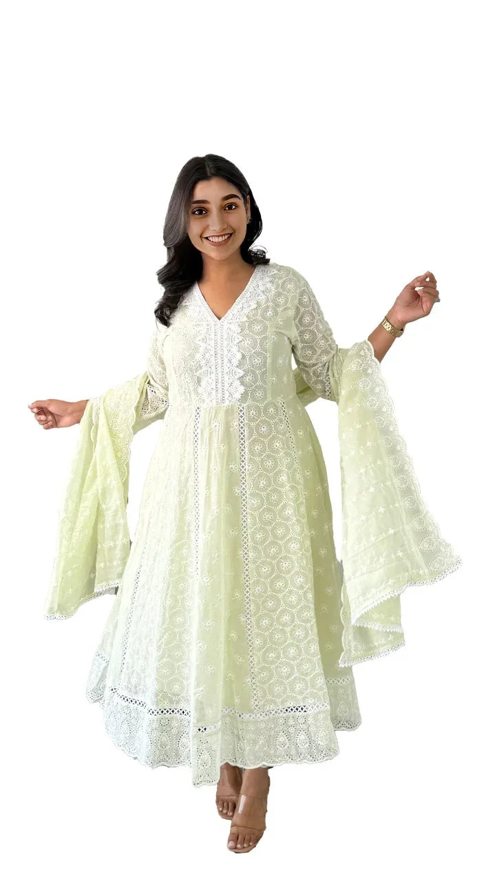 Woman wearing a soft cotton anarkali for women in light green with intricate embroidery and flared sleeves