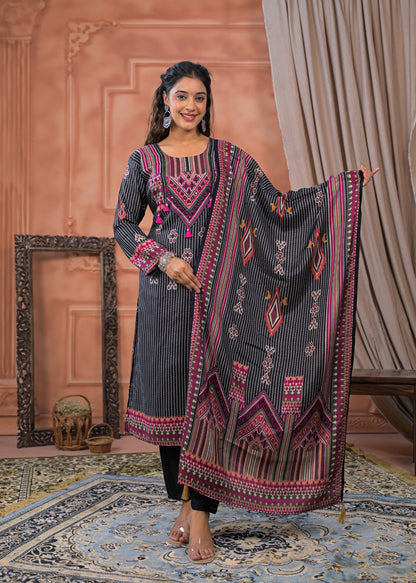 Woman wearing a black striped embroidered suit set with pink and orange geometric patterns and matching dupatta