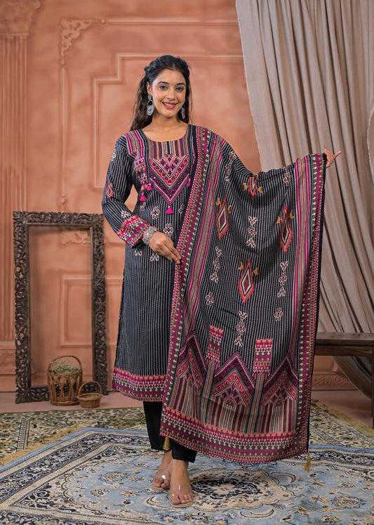 Woman wearing a black striped embroidered suit set with pink and orange geometric patterns and matching dupatta