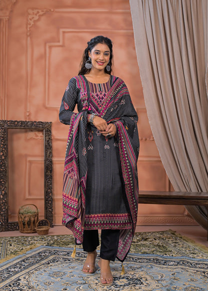 Woman wearing black striped embroidered suit set with pink detailed embroidery and matching dupatta