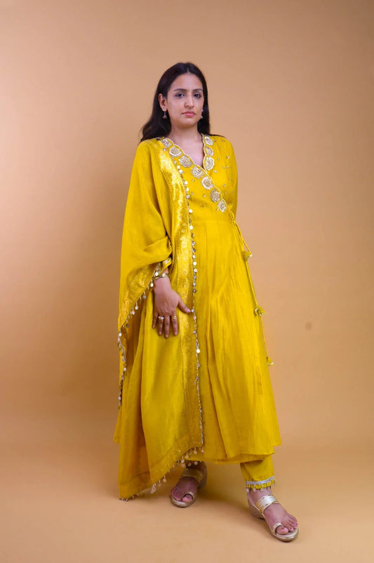 Woman wearing a yellow embroidered angrakha set with matching dupatta and pants from Dharini's Store