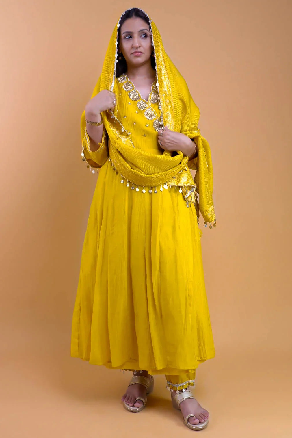 Woman wearing yellow embroidered angrakha set with detailed embellishments and matching dupatta from Dharini's Store