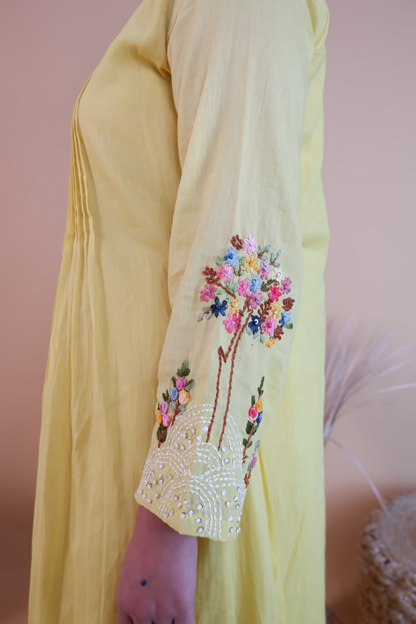 Yellow embroidered cotton dress sleeve with colorful floral embroidery and bead detailing