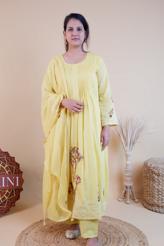 Woman wearing yellow embroidered cotton dress with floral designs and matching dupatta from Dharini's Store